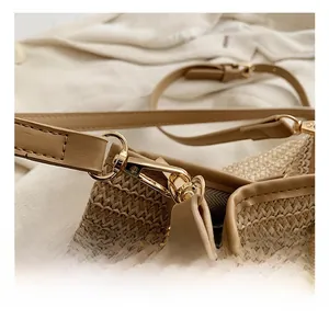 Detailed macro view of high-quality golden metal hook and woven straw texture on bag