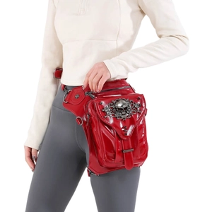 Steampunk red glossy thigh bag with skull relief and metal chain on white background