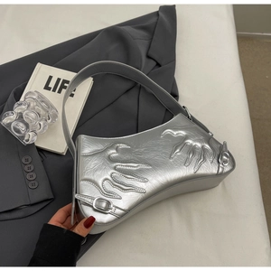 Detail view of silver baguette bag with flame embossed texture and buckle strap