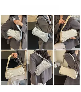 Close-up of minimalist bag featuring unique palm relief pattern and adjustable strap details