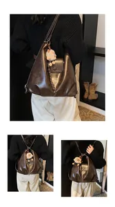 Detail view of dark brown retro leather crossbody bag with flap closure and plush charm