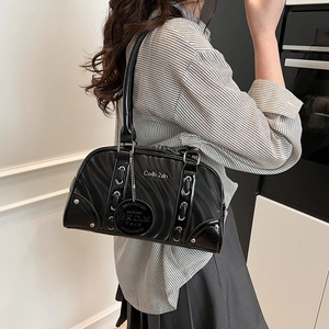Chic black patent leather Boston bag with wave texture and silver stud accents