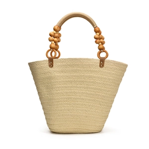 Handmade woven straw tote bag with beaded handle and large capacity for beach vacation