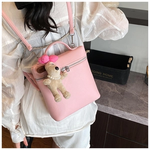 Pink lychee texture backpack with adjustable straps and a cute plush dog pendant