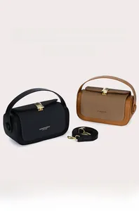 Detail of vintage box bags in black and brown with metal buckles and woven texture
