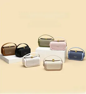 Collection of minimalist mini box bags in seven colors with gold metallic turn-lock clasps
