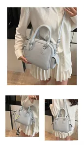 Detail of light blue tote bag with heart pendant and functional side pocket for women