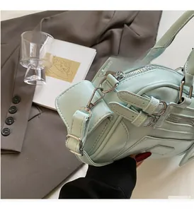Detailed shot of light green leather handbag featuring premium silver metal hardware accents