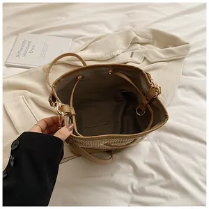 Top view showing the spacious interior with drawstring closure on a straw bucket bag