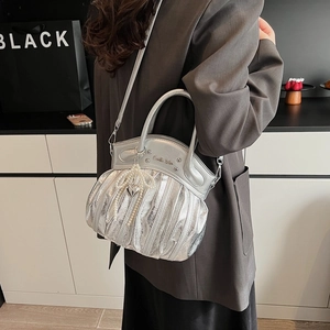 Silver pleated motorcycle crossbody bag with pearl bow and heart charm detail