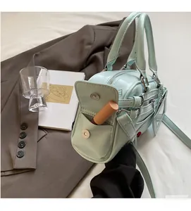 Close-up of mint green Boston bag side pocket showing lipstick storage and metal zipper