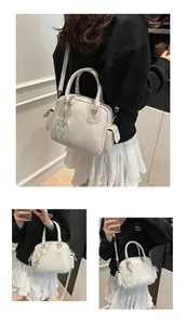 Detailed views of a beige high-capacity tote bag with a heart charm and strap