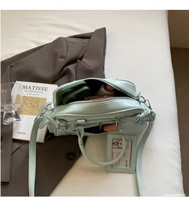 Detail view of mint green handbag interior showing storage capacity and inner lining