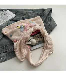 Pink knit tote bag with 3D floral lace and pearls showing large internal storage capacity