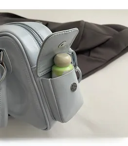 Light blue tote bag detail showing the side magnetic pocket storing a small bottle