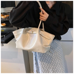 Detail of off-white pleated shoulder bag with long straps and metal buckle hardware