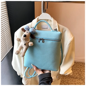 Sky blue litchi grain leather mini backpack with cute plush puppy charm and silver zipper