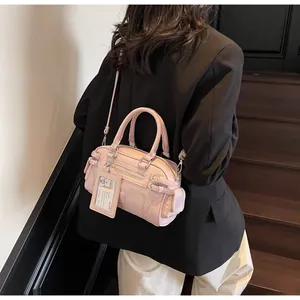 Pink matte PU leather Boston bag with metal zippers and detachable card holder detail