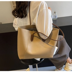 Mannequin portant un grand cabas minimaliste beige avec anses brunes pour le style quotidien