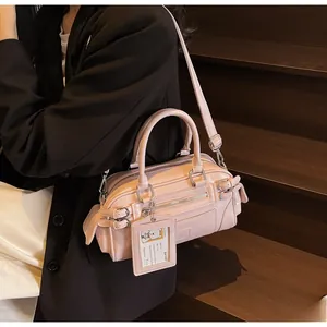 Pink Boston style handbag featuring multiple zippers, adjustable strap, and card holder detail