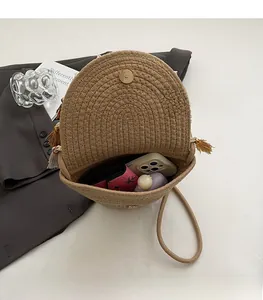Internal view showing the spacious capacity of this round straw bag with a magnetic closure