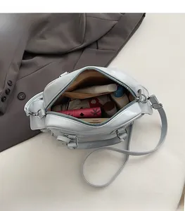 Detail view of large light blue tote bag interior showing spacious capacity and pockets