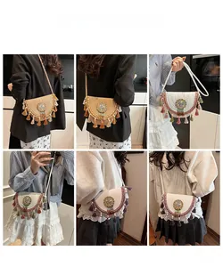 Detail of straw woven crossbody bag with colorful tassels and ethnic beaded patterns