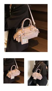Pink Boston handbag details featuring metal zippers and detachable clear ID tag accessory