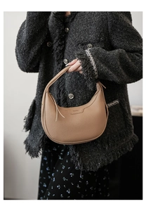 Detail der hellbraunen Halbmond-Hobo-Tasche mit Lychee-Narbung und Lederetikett