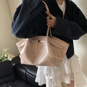 Beige large pleated tote bag with glossy finish and long shoulder straps for women