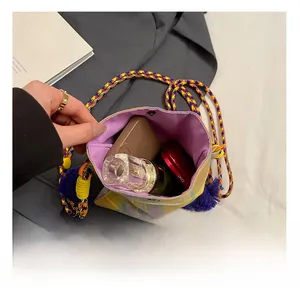 Detail view of the colorful plaid crossbody bag showing inner storage capacity and purple lining