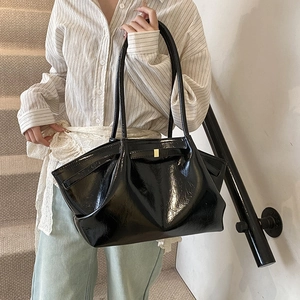 Large black pleated tote bag in glossy patent leather with gold buckle detail