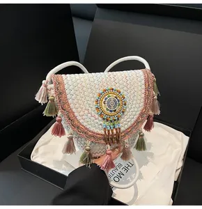Detail of bohemian woven bag with colorful tassels and beads in a premium gift box