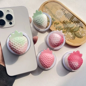 Macro shot of 3D strawberry phone grip with gradient frosted texture and foldable base