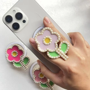Floral pearl phone socket grip with retractable magnetic stand on white smartphone