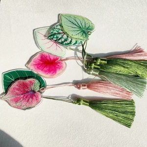 Acrylic monstera leaf bookmarks with colorful plant veins and matching silky tassels
