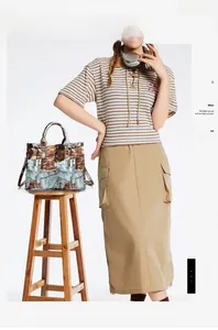 Detail of vintage patchwork tote bag featuring denim and brown leather with front pockets