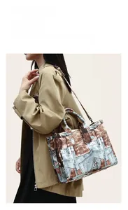 Detail of vintage patchwork denim print tote bag styled with a khaki trench coat