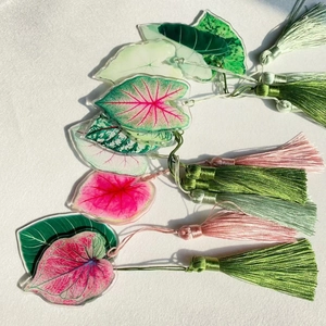 Custom acrylic monstera leaf bookmarks with elegant silk tassels in various vibrant colors