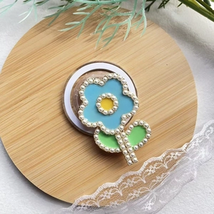 Detailed view of floral magnetic phone holder with light blue petals and pearl edge