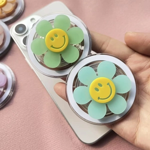 Magnetic flower smiley face phone grip holder with matte jelly petals on a smartphone