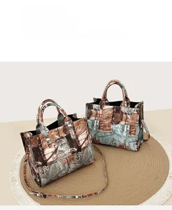 Detailed view of vintage denim print tote bag with adjustable strap on jute mat