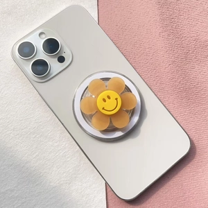 Detail of a cute yellow flower magnetic phone socket with a classic smiley face icon