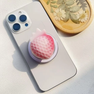 Detail of 3D strawberry phone grip with frosted gradient texture on smartphone back