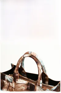 Detail view of thickened handles and brown contrast edge on vintage patchwork tote bag