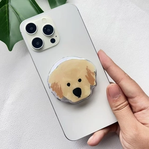 Close-up of a cute golden retriever acrylic phone grip on a white smartphone