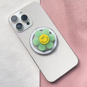Detail of floral smiley face magnetic phone socket stand on a white smartphone
