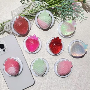 Detail view of colorful resin strawberry phone grips with textured glitter finish