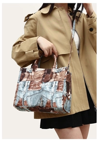 Detail of vintage denim print tote bag with realistic pocket patterns and leather trim