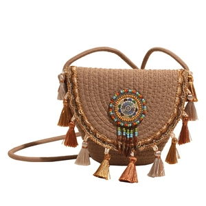 Bohemian woven straw shoulder bag with colorful beads and decorative silk tassels